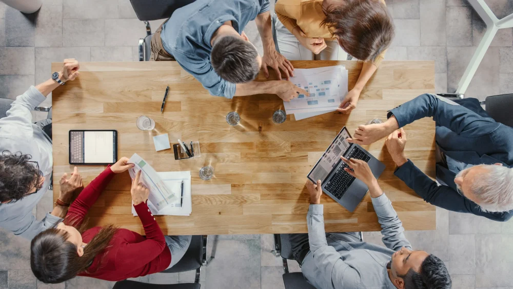Startup Meeting Room: Team of Entrepreneurs sitting at the Conference Table