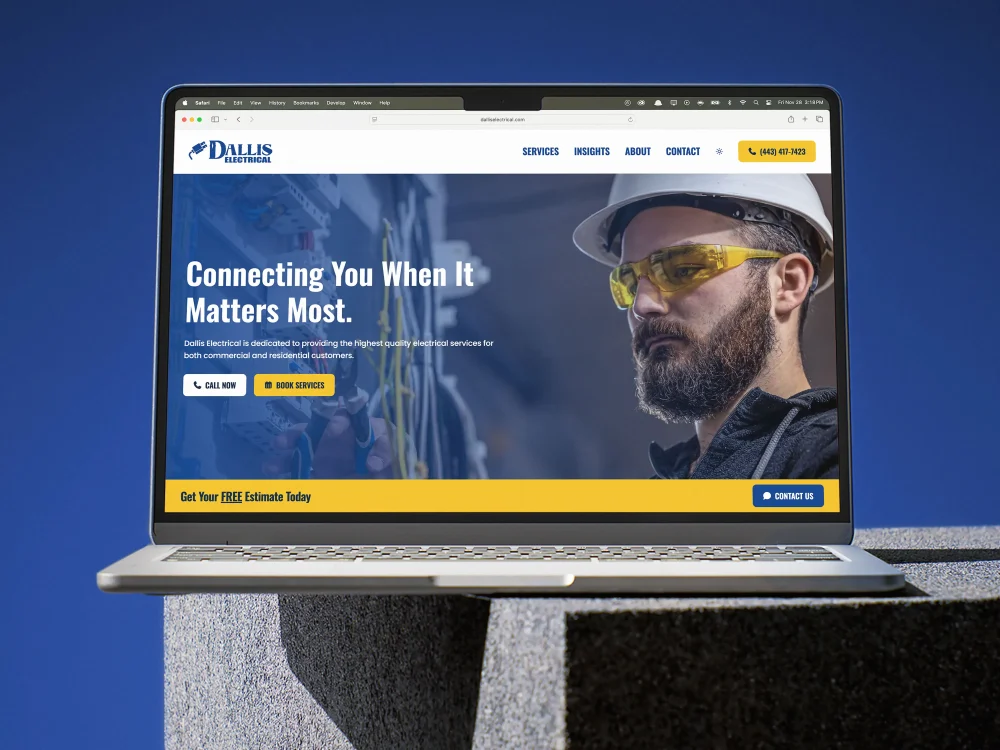 A laptop displaying the home page of the Dallis Electrical Services website.